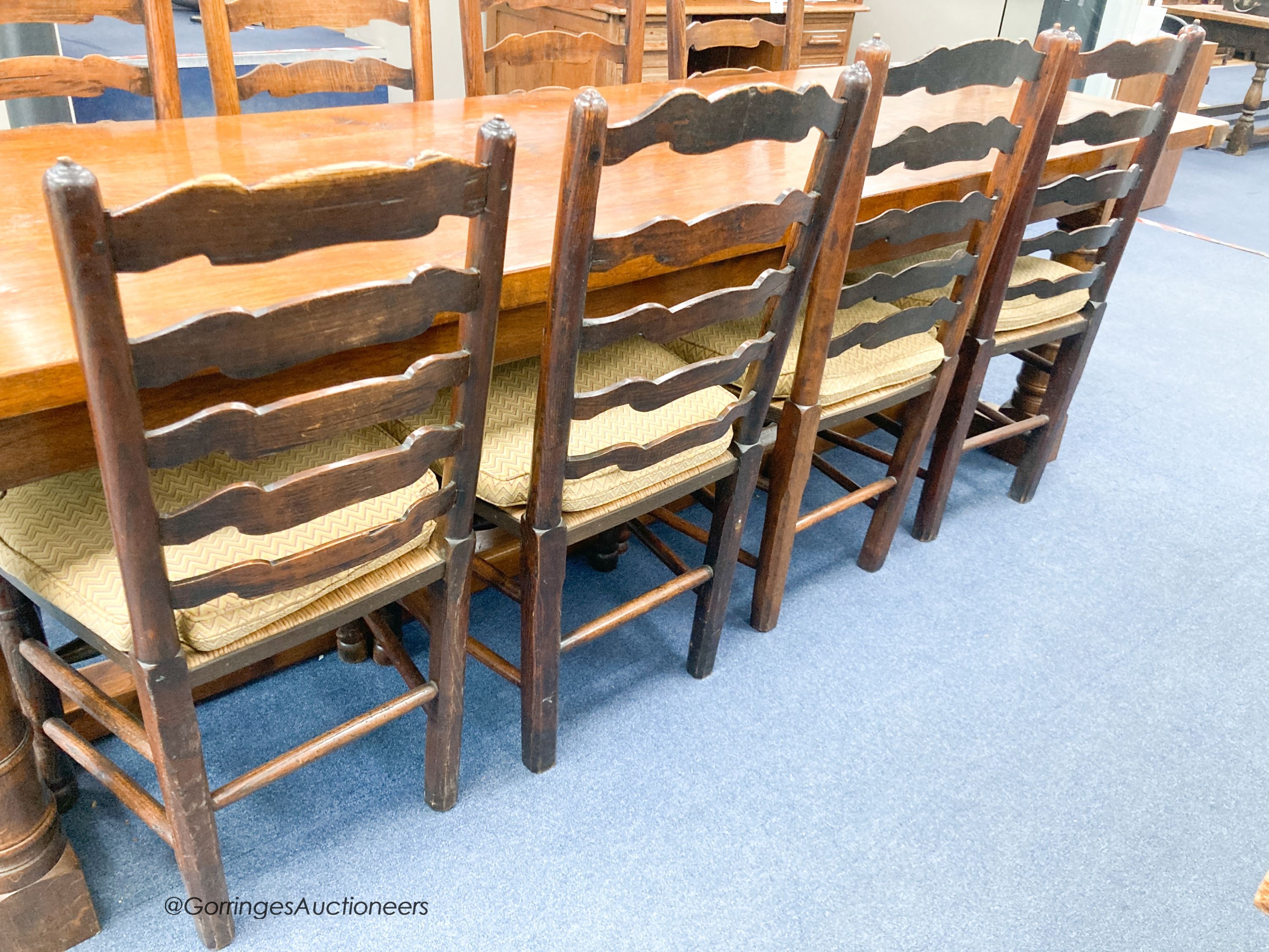 A harlequin set of eight ash rush seat ladder back dining chairs with squab seats